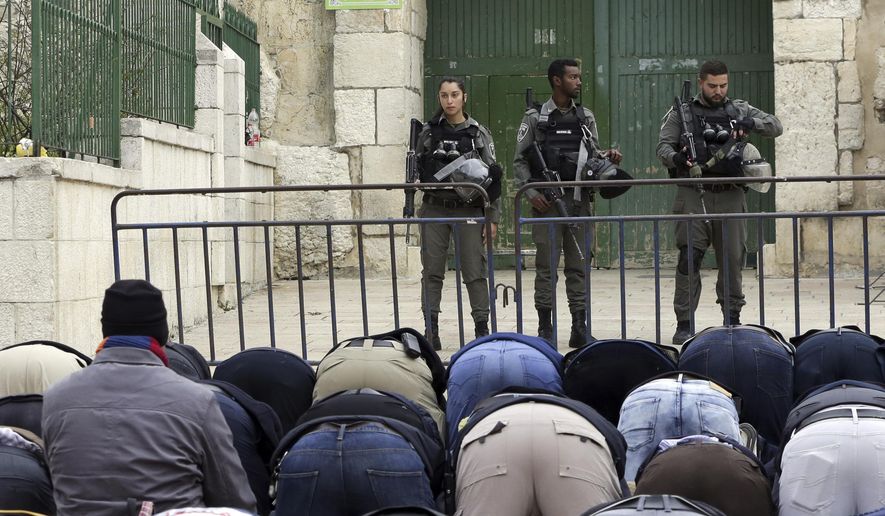 Palestinians pray outside the Old City as Israeli border police blocked the entrances to Al-Aqsa compound in Jerusalem Tuesday, March 12, 2019. Israeli police on Tuesday closed the entrances to Jerusalem's most sensitive holy site after Palestinian suspects threw a firebomb at a police station. (AP Photo/Mahmoud Illean)