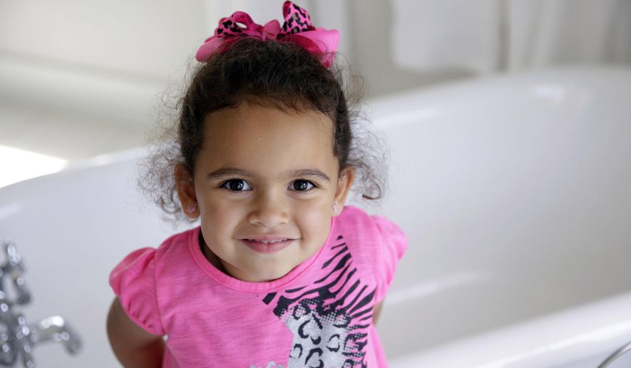 FILE - In this Aug. 6, 2013, file photo, Veronica, 3, a child at the center of an international adoption dispute at the time, smiles in a bathroom of the Cherokee Nation Jack Brown Center in Tahlequah, Okla. A federal law that gives preference to Native American families in child welfare proceedings involving Native children is facing a significant legal challenge. In 2013, the U.S. Supreme Court ruled the law didn’t apply in a South Carolina case involving Veronica because her Cherokee father was absent from part of her life. (Mike Simons/Tulsa World via AP, File)