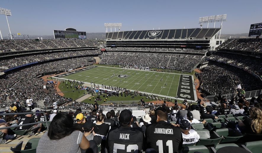 FILE - In this Oct. 8, 2017, file photo, fans watch during the first half of an NFL football game between the Oakland Raiders and the Baltimore Ravens at Oakland Alameda County Coliseum in Oakland, Calif. A lease agreement to keep the Raiders in Oakland for at least one more season will be voted on this week. The Coliseum Authority has scheduled a vote for Friday, March 15, 2019, on a lease with the Raiders for 2019 with an option for 2020. (AP Photo/Marcio Jose Sanchez, File)