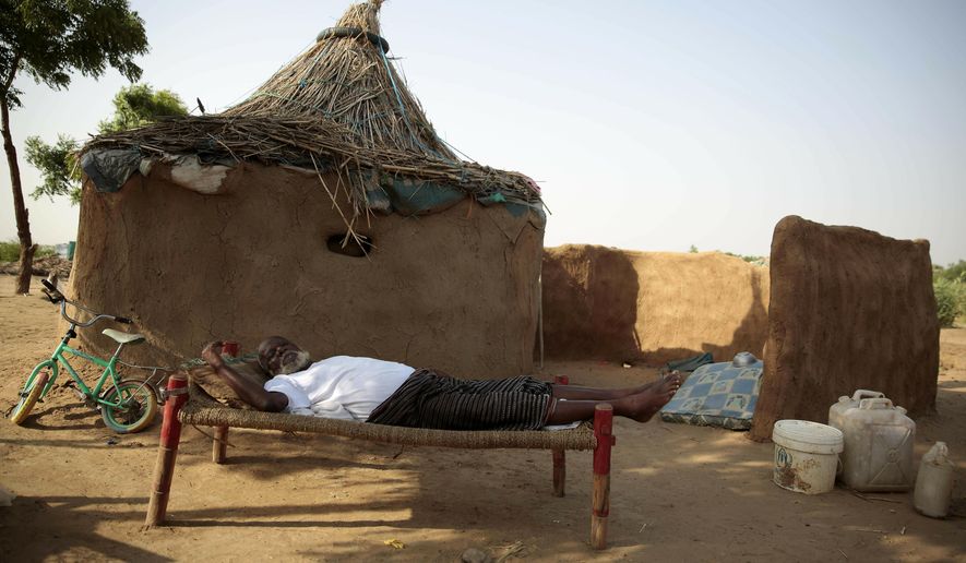 FILE - In this Oct. 7, 2016 file photo, a man rests on a bed in front of his hut at a camp for internally displaced people near the town of Abs, in the Hajjah governorate, of Yemen. The U.N. Office for the Coordination of Humanitarian Affairs, or OCHAU.N. warned in a report Tuesday, March 12, 2019, that thousands of Yemeni civilians caught in fierce clashes between warring factions are trapped in the embattled northern district of Hajjah. The number of displaced in the district has doubled over the past six months, the humanitarian agency said. (AP Photos Hani Mohammed, File)