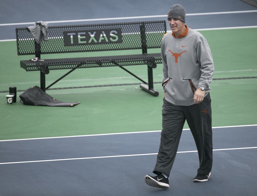 Texas' head coach Michael Center, in his 18th season, surveys the courts before the matches with UTSA., Jan. 19, 2018 in Austin, Texas. The Inaugural Matches at the new Texas Tennis Center are being held Friday afternoon January 19-21, 2018, as the University of Texas Men's team opens against UTSA. (Ralph Barrera/Austin American-Statesman via AP)