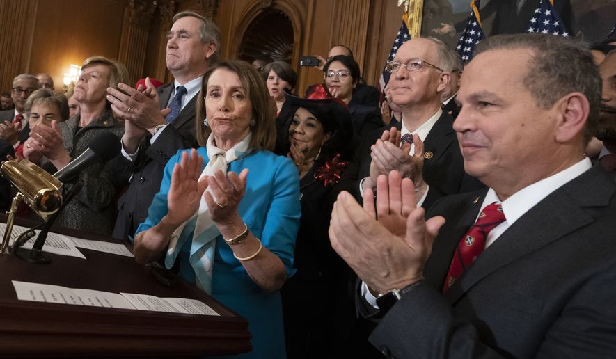 Speaker of the House Nancy Pelosi, D-Calif., flanked by Sen. Jeff Merkley, D-Ore., left, and Rep. David Cicilline, D-R.I., right, applauds with fellow Democrats as they announce the introduction of The Equality Act, a comprehensive nondiscrimination bill for LGBT rights, at the Capitol in Washington, Wednesday, March 13, 2019. (AP Photo/J. Scott Applewhite)