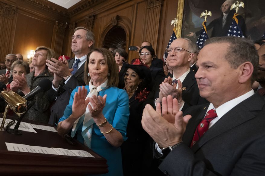 Speaker of the House Nancy Pelosi, D-Calif., flanked by Sen. Jeff Merkley, D-Ore., left, and Rep. David Cicilline, D-R.I., right, applauds with fellow Democrats as they announce the introduction of The Equality Act, a comprehensive nondiscrimination bill for LGBT rights, at the Capitol in Washington, Wednesday, March 13, 2019. (AP Photo/J. Scott Applewhite)