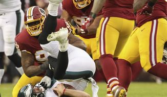 FILE - In this Sunday, Dec. 30, 2018, file photo, Washington Redskins defensive tackle Stacy McGee (92) sacks Philadelphia Eagles quarterback Nick Foles (9) during the first half of the NFL football game, in Landover, Md. On Wednesday, March 13, 2019, the Redskins released linebacker Zach Brown and defensive lineman Stacy McGee as part of a remaking of their defense. (AP Photo/Andrew Harnik, File)