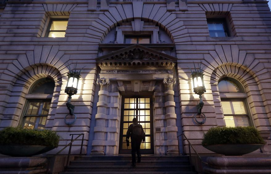 FILE - In this Feb. 9, 2017, file photo, a man walks up the steps of the 9th U.S. Circuit Court of Appeals building in San Francisco. The Trump administration will try to convince a federal appeals court to block California laws aimed at protecting immigrants in one of the many ongoing lawsuits between the White House and the Democrat-dominated state. At issue in the Wednesday, March 13, 2019, hearing before the 9th U.S. Circuit Court of Appeals is a March 2018 lawsuit by the administration over three California laws that extended protections to people in the country illegally. (AP Photo/Marcio Jose Sanchez, File)