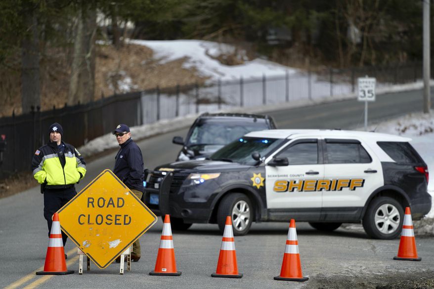 Berkshire County Sheriff Department officers close off the road Wednesday, March 13, 2019, in Sheffield, Mass., to a home where investigators work at the scene of a house fire that killed five people. (Ben Garver/The Berkshire Eagle via AP)