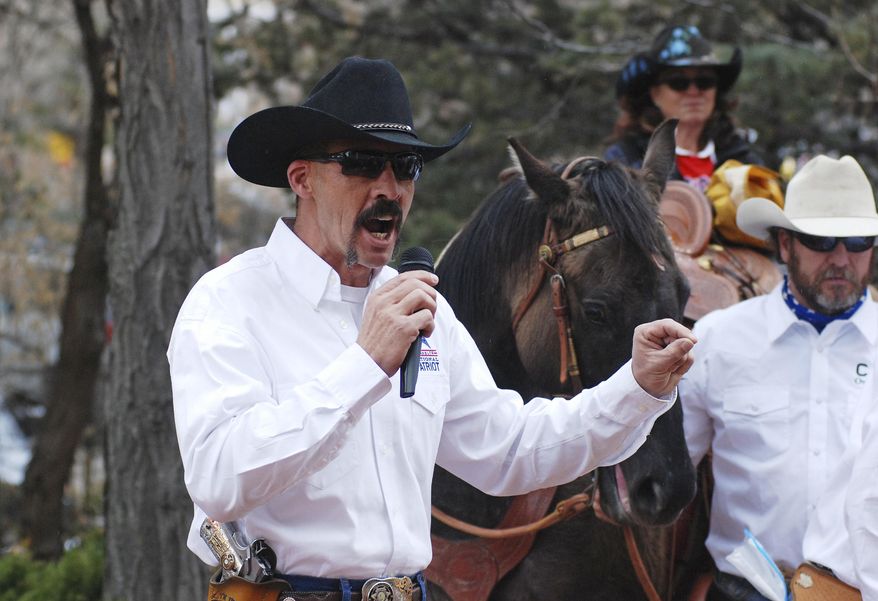 Cibola County Sheriff Tony Mace rallies protesters against gun control legislation at a gathering outside the New Mexico state Capitol, on Tuesday, March 12, 2019. Advocates for gun rights in New Mexico including rural ranchers joined with a interstate group called Cowboys for Trump at a protest against Democrat-sponsored gun control legislation and a bill that removes the state's dormant ban on abortion. Democratic New Mexico Gov. Michelle Lujan Grisham last week signed a bill to expand background checks on private gun sales. (AP Photo/Morgan Lee)