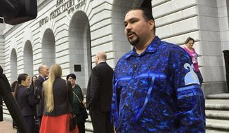 Tehassi Hill, tribal chairman of the Oneida Nation, stands outside a federal appeals court Wednesday, March 13, 2019, in New Orleans, following arguments on the constitutionality of a law giving Native American families preference in the adoption of Native American children. (AP Photo/Kevin McGill) ** FILE **