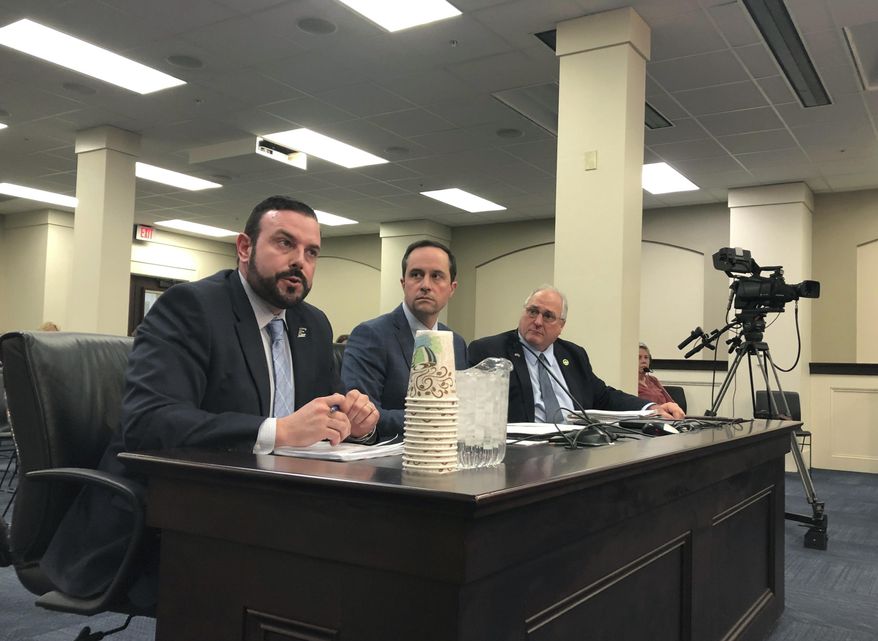 In this Monday, March 11, 2019 photo, Eastern Kentucky University Vice President David McFaddin, left, speaks to lawmakers about a proposal that would let the university and other quasi-governmental entities leave the state's struggling pension system, in Frankfort, Ky. Lawmakers are scheduled to approve a bill Wednesday, March 13 that would allow these agencies to leave the system without paying what they owe. It would make one of the country's worst-funded pension systems even more underfunded, but lawmakers say they have no choice because the agencies can't afford to pay higher pension contribution rates. (AP Photo/Adam Beam)