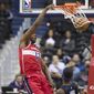 Washington Wizards center Thomas Bryant (13) dunks in front of Orlando Magic guard Terrence Ross, left, and center Khem Birch during the first half of an NBA basketball game Wednesday, March 13, 2019, in Washington. (AP Photo/Alex Brandon) **FILE**