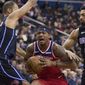 Washington Wizards guard Bradley Beal, center, drives between Orlando Magic guard Evan Fournier, from France, and center Khem Birch during the second half of an NBA basketball game Wednesday, March 13, 2019, in Washington. The Wizards won 100-90. (AP Photo/Alex Brandon)