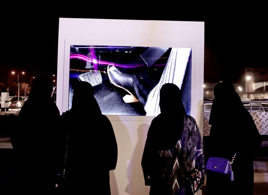 FILE - In this June 22, 2018 file photo, women watch a video about driving at a road safety event for female drivers launched at the Riyadh Park Mall in Saudi Arabia. Women's rights activists in Saudi Arabia appeared in a closed-door court hearing on unknown charges, Wednesday, March 13, 2019, after being detained in a crackdown last year, making their first appearance before a judge in the internationally criticized case. (AP Photo/Nariman El-Mofty, File)