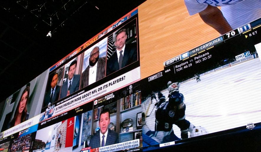 This March 8, 2019 photo shows giants video screens inside the sports betting lounge at the Tropicana casino in Atlantic City N.J. Figures released on March 13, 2019 show New Jersey gamblers have wagered almost $2 billion on sporting events since it started nine months ago. (AP Photo/Wayne Parry) **FILE**