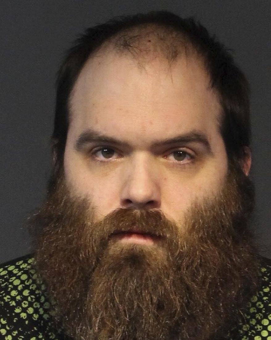 This March 12, 2019, photo provided by the Washoe County Sheriff's Office shows Scott Petersen, 30, of Sun Valley, Nev., at the Washoe County Jail in Reno, Nev. Petersen was being held in the jail without bail Wednesday on multiple charges of battery, assault with a deadly weapon and child abuse after deputies say he shot a man then locked himself in a bedroom of a residence with a child. (Washoe County Sheriff's Office via AP)