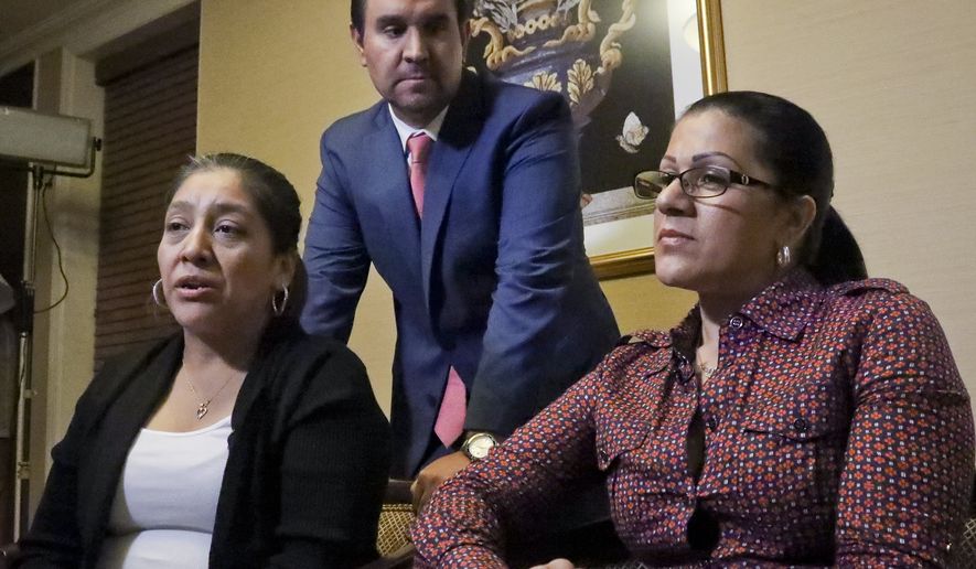 Attorney Anibal Romero, center, joins his clients Victorina Morales, left, and Sandra Diaz, right, during an interview, Friday Dec. 7, 2018, in New York. Morales and Diaz, who recalled their experience working at President Donald Trump&#x27;s golf resort in Bedminster, N.J., say they used false legal documents to get hired and supervisors knew it. (AP Photo/Bebeto Matthews)