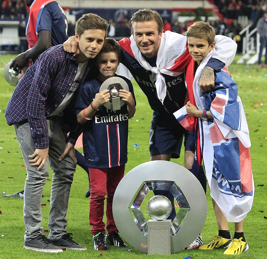 David Beckham, 4 kids Paris Saint-Germain's midfielder David Beckham from England, center, poses with the cup surrounded by his sons, Brooklyn, left, Cruz, second from left, and Romeo James, right, as he celebrates PSG's French League One title, at the Parc des Princes Stadium, in Paris, Saturday, May 18, 2013. The match was his final home game for Paris Saint-Germain before retirement. (AP Photo/Thibault Camus)