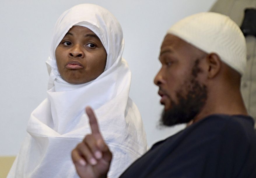 In this Aug. 13, 2018, photo, defendants Hujrah Wahhaj, left, and Siraj Wahhaj talk during a break in court hearings in Taos, N.M. The Wahhajs were among several people arrested after authorities raided a property and found 11 children living on a squalid compound on the outskirts of tiny Amalia, N.M. The five men and women found living in a ramshackle compound in northern New Mexico where a boy was found dead last year have been indicted on federal charges related to terrorism, kidnapping and firearms violations. The U.S. attorney's office in New Mexico announced the superseding indictment Thursday, March 14, 2019. (Roberto E. Rosales/The Albuquerque Journal via AP) **FILE**