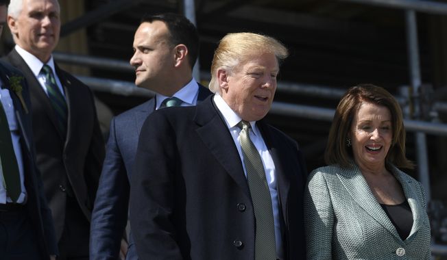 House Speaker Nancy Pelosi of Calif., right, talks with President Donald Trump, second from right, as Irish Prime Minister Leo Varadkar, second from left, and Vice President Mike Pence, left, follow as they walks down the steps of the Capitol in Washington, Thursday, March 14, 2019, following a lunch. (AP Photo/Susan Walsh)