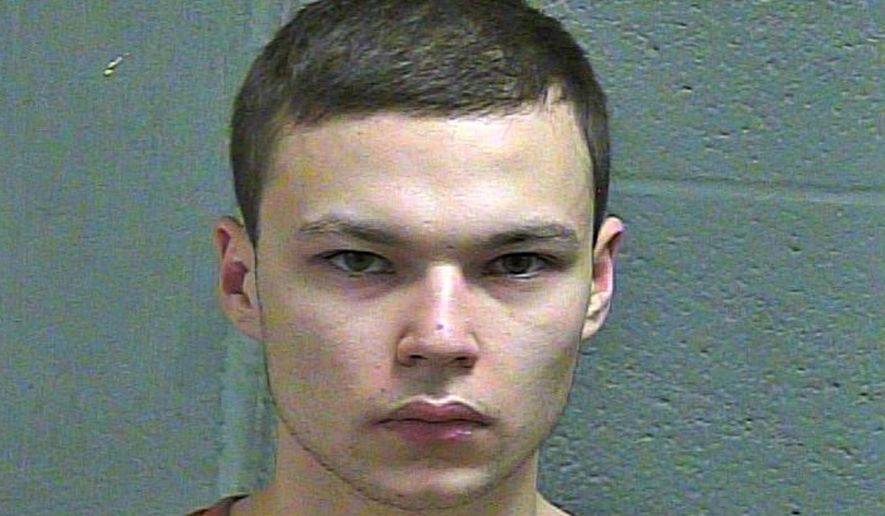 FILE--This March 4, 2019 booking photo released by the Oklahoma County Sheriff's Office shows Michael Elijah Walker. Police say the 19-year-old Oklahoma man told his younger brother that he fatally shot their parents because they were communicating with him telepathically and were Satan worshippers. Walker has pleaded not guilty to first-degree murder in his parents deaths and his attorney Derek Chance says he will seek to have Eli Walker declared mentally incompetent. (Oklahoma County Sheriff's Office via AP)