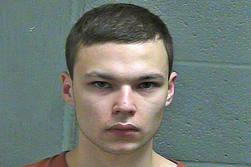 FILE--This March 4, 2019 booking photo released by the Oklahoma County Sheriff's Office shows Michael Elijah Walker. Police say the 19-year-old Oklahoma man told his younger brother that he fatally shot their parents because they were communicating with him telepathically and were Satan worshippers. Walker has pleaded not guilty to first-degree murder in his parents deaths and his attorney Derek Chance says he will seek to have Eli Walker declared mentally incompetent. (Oklahoma County Sheriff's Office via AP)