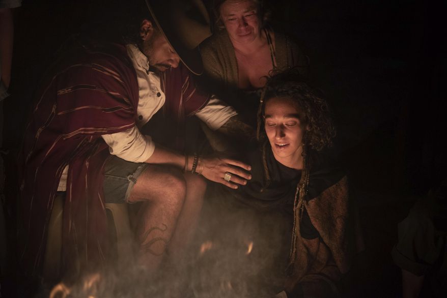 In this Tuesday, March 12, 2019 photo, Elena Consolini, right, is comforted by Francisco Rosales as they attend a memorial for their friend Catherine Shaw at a hotel in San Pedro La Laguna, Guatemala. Shaw, an English tourist whose body was found near a Guatemala highland lake popular with travelers, died of hemorrhaging resulting from a traumatic brain injury, according to an autopsy report completed Tuesday. (AP Photo/Santiago Billy)