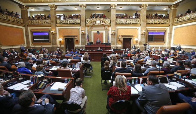 FILE - In this Jan. 28, 2019, file photo, the floor of the Utah House of Representatives is shown during the first day of the Utah legislative session, in Salt Lake City. Utah lawmakers were set Thursday, March 14, 2019, to end their annual legislative session after scaling back a voter-approved Medicaid expansion, passing a long-awaited update to the state's hate crimes law and reaching a deal to increase the alcohol level in beer. Measures on other hot-button issues failed to pass, like a ban on LGBT conversion therapy. Lawmakers also passed two anti-abortion measures. (AP Photo/Rick Bowmer, File)