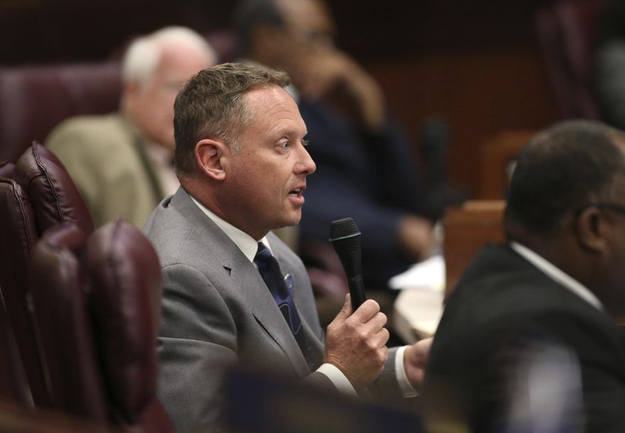 FILE - In this Sept. 10, 2014, file photo, Nevada Assemblyman Mike Sprinkle, D-Sparks, asks questions in a special session of the Nevada Legislature, in Carson City, Nev. Sprinkle says he is resigning because he faces sexual harassment complaints, making him the second high-ranking Democratic state legislator to resign in under two weeks. Sprinkle's resignation announcement Thursday, March 14, 2019, offered no details about the claims made against him but follows the resignation of Senate's Democratic majority leader Kelvin Atkinson last week. (AP Photo/Cathleen Allison, File)