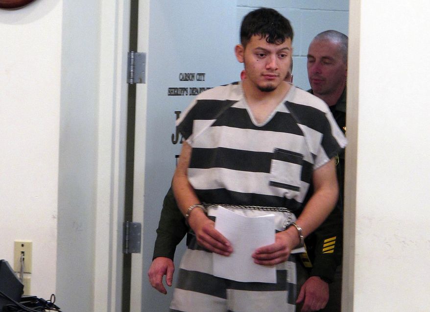 FILE - In this Jan. 24, 2019 file photo, Wilber Ernesto Martinez-Guzman, 19, of El Salvador, is escorted into the courtroom for his initial appearance in Carson City Justice Court in Carson City, Nev. A grand jury has indicted Martinez-Guzman on murder charges in the killing of four northern Nevadans in January. The district attorneys for Washoe and Douglas counties scheduled a news conference in Reno Thursday, March 14, 2019, to provide an update on the case, including their decision on whether to seek the death penalty for Martinez-Guzman.(AP Photo/Scott Sonner, File)