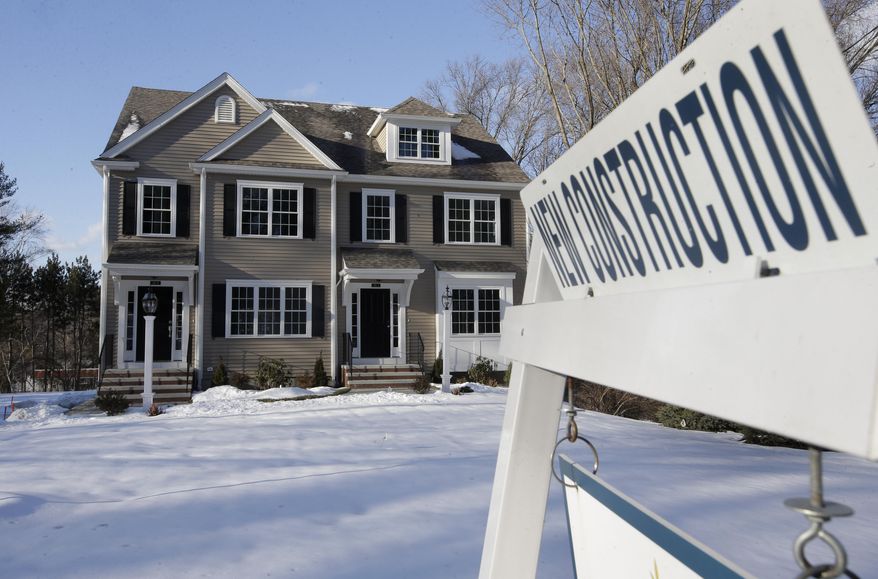 In this Thursday, Feb. 21, 2019 photo a sign is posted near a newly constructed home in Natick, Mass. On Thursday, March 14, the Commerce Department reports on sales of new homes in January. (AP Photo/Steven Senne)