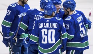 Vancouver Canucks&#x27; Alexander Edler, of Sweden; Josh Leivo; Markus Granlund, of Finland; Brock Boese; and Bo Horvat celebrate Boeser&#x27;s goal against the New York Rangers during the second period of an NHL hockey game Wednesday, March 13, 2019, in Vancouver, British Columbia. (Darryl Dyck/The Canadian Press via AP)