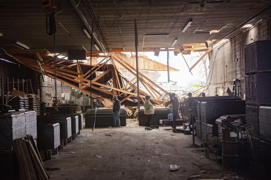 This Thursday, March 14, 2019 photo shows damage to the Wilbert Vault Co., in West Paducah, Ky. A tornado left a path in western Kentucky from Lovelaceville through the West Paducah area, according to Keith Todd, a spokesman for the Kentucky Transportation Cabinet. He said the public was being asked to avoid the area while utility crews, area fire departments, and rescue squads worked to clear utility lines, downed trees and other debris. (Dave Thompson/The Paducah Sun via AP)