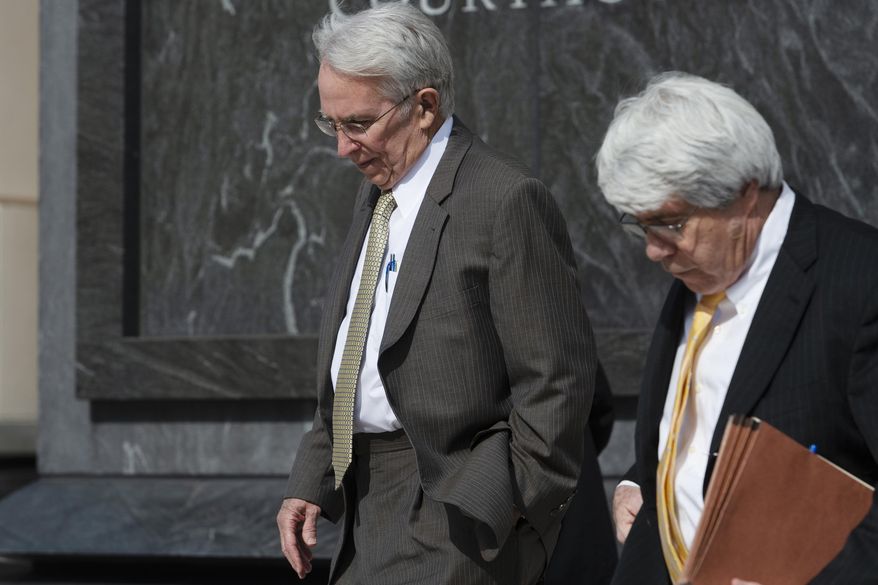 Former West Virginia Supreme Court Justice Menis Ketchum, left, leaves federal court with his attorney, Jim Calle, Wednesday, March 6, 2019, in Charleston, W.Va. Ketchum was sentenced to three years probation for using a state vehicle and gas fuel card for a 2014 golf trip to Virginia. Ketchum was also fined $20,000 and ordered to pay $749 in restitution for his guilty plea last year to a felony fraud count. (Craig Hudson/Charleston Gazette-Mail via AP)