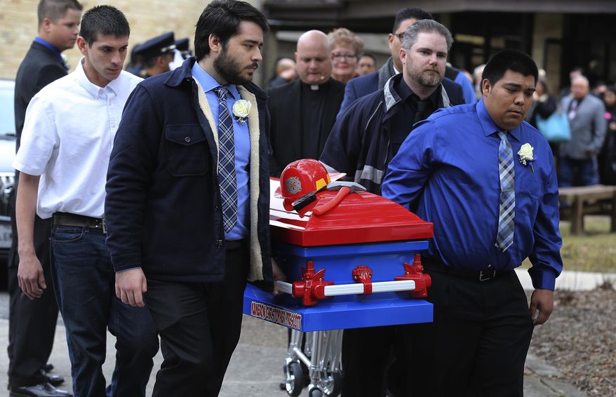 In this Dec. 28, 2017, photo pallbearers carry the firefighter-themed casket of six-year-old Kameron Prescott after a church service in Schertz, Texas. Four Texas sheriff’s deputies won’t face charges for opening fire on a suspected car thief, killing her and Prescott who they didn’t know was nearby, according to a grand jury’s decision this week. (Kin Man Hui/The San Antonio Express-News via AP)