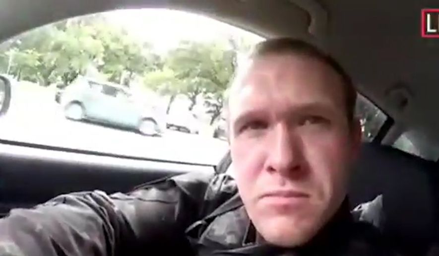 This image taken from the alleged shooters video, which was filmed Friday, March 15, 2019, shows him as he drives and he looks over to three guns on the passenger side of his vehicle in New Zealand. A witness says many people have been killed in a mass shooting at a mosque in the New Zealand city of Christchurch. Police have not described the scale of the shooting but urged people to stay indoors. (AP Photo)
