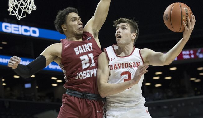 Davidson guard Jon Axel Gudmundsson (3) goes to the basket against Saint Joseph&#x27;s forward Lorenzo Edwards (21) during the first half of an NCAA college basketball game in the Atlantic 10 Conference tournament, Friday, March 15, 2019, in New York. (AP Photo/Mary Altaffer)