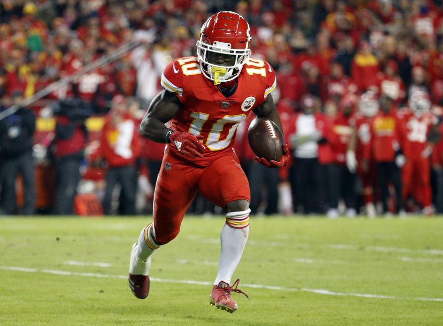 FILE - In this Dec. 13, 2018, file photo, Kansas City Chiefs wide receiver Tyreek Hill (10) runs with the ball during the first half of the team's NFL football game against the Los Angeles Chargers in Kansas City, Mo. The Chiefs are investigating an incident in which Hill was involved in a domestic battery episode in suburban Kansas City earlier this week. The team said in a statement to The Associated Press that it was aware of a police report filed Thursday, March 14, by the Overland Park Police Department that lists Hill’s address and identifies a juvenile as the victim. Hill’s fiancee, Crystal Espinal, is identified among “others involved.” (AP Photo/Charlie Riedel, File)