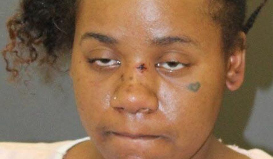 This photo provided by Baltimore Police shows Nichole George, charged in the shooting of an 11-year-old boy and his mother at a Baltimore playground. Baltimore police said in a Friday, March 15, 2019 release that 31-year-old Nichole George has been charged with attempted first-degree murder, assault and handgun violations in connection with the Wednesday evening shooting. (Baltimore Police via AP)