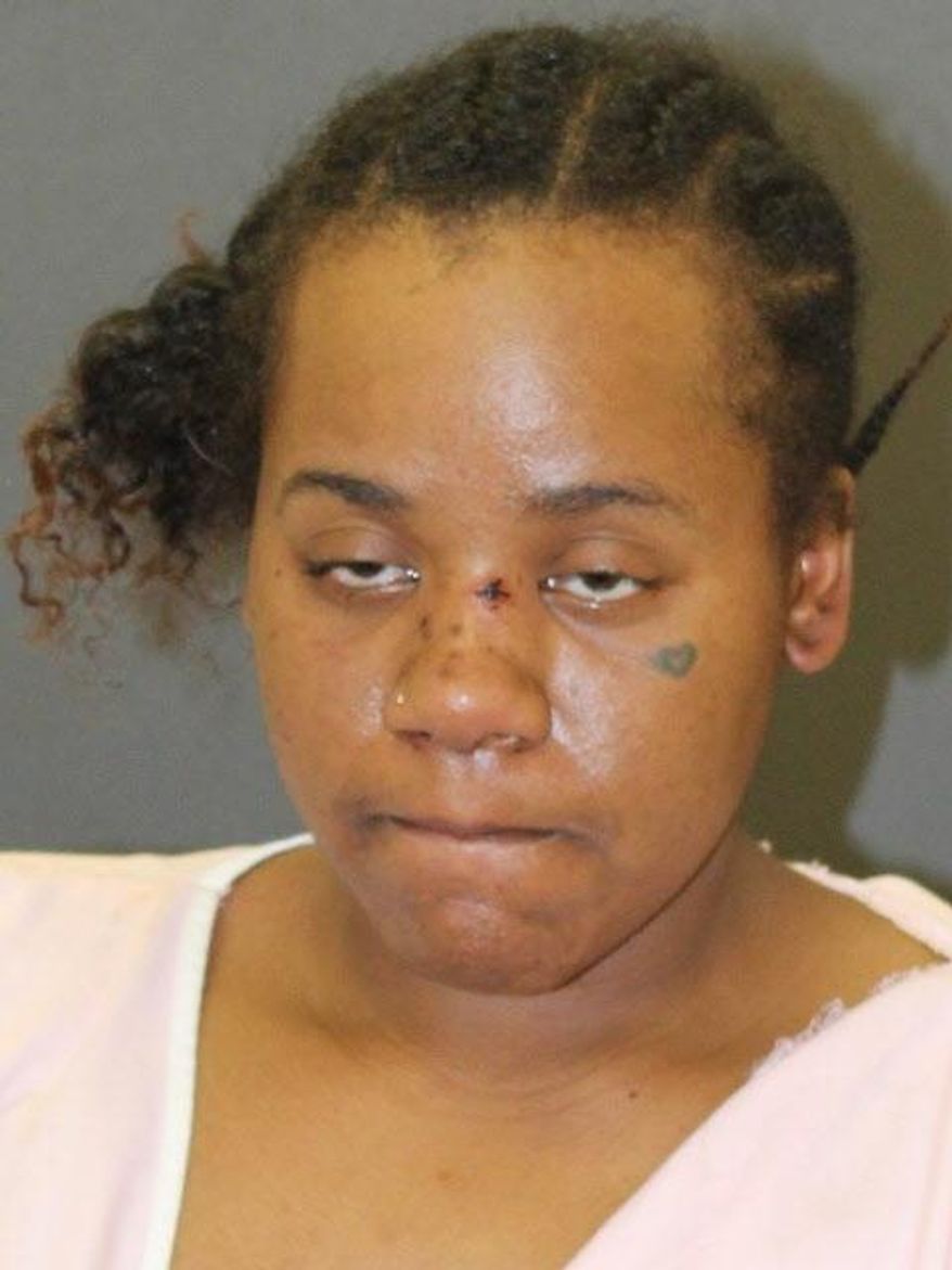 This photo provided by Baltimore Police shows Nichole George, charged in the shooting of an 11-year-old boy and his mother at a Baltimore playground. Baltimore police said in a Friday, March 15, 2019 release that 31-year-old Nichole George has been charged with attempted first-degree murder, assault and handgun violations in connection with the Wednesday evening shooting. (Baltimore Police via AP)