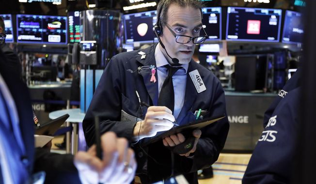 FILE- In this March 5, 2019, file photo trader Gregory Rowe works on the floor of the New York Stock Exchange. The U.S. stock market opens at 9:30 a.m. EDT on Friday, March 15. (AP Photo/Richard Drew, File)