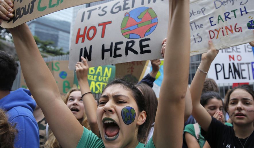 Hundreds of schoolchildren take part in a climate protest in Hong Kong, Friday, March 15, 2019. Students in more than 80 countries and territories worldwide plan to skip class Friday in protest over their governments' failure to act against global warming. The coordinated 'school strike' was inspired by 16-year-old activist Greta Thunberg, who began holding solitary demonstrations outside the Swedish parliament last year. (AP Photo/Kin Cheung)