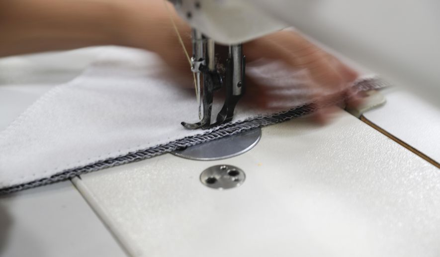 FILE- In this July 5, 2018, file photo a worker sews the Afloat water bed at the factory in Corona, Calif. On Friday, March 15, 2019, the Federal Reserve reports on U.S. industrial production for February. (AP Photo/Chris Carlson, File)