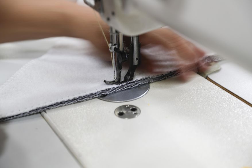 FILE- In this July 5, 2018, file photo a worker sews the Afloat water bed at the factory in Corona, Calif. On Friday, March 15, 2019, the Federal Reserve reports on U.S. industrial production for February. (AP Photo/Chris Carlson, File)