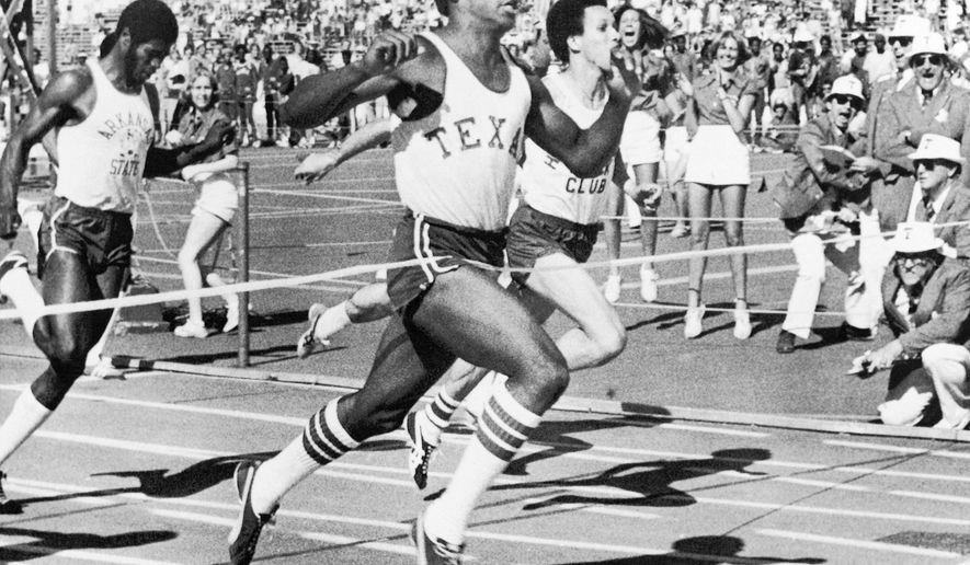 FILE - In this April 2, 1977, file photo, Olympic gold medal winner Johnny Jones, of the University of Texas, breaks the tape in 9.85 to set a new world record for a hand-timed 100-meter dash event during competition at the Texas relays in Austin, Texas. The former University of Texas wide receiver and track standout, who won an Olympic relay gold medal in 1976, has died after a long bout with cancer, the school announced Friday, March 15, 2019. He was 60. (AP Photo/Ted Powers, File)