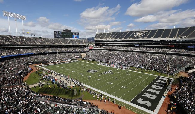 FILE - In this Oct. 28, 2018, file photo, fans watch during the first half of an NFL football game between the Oakland Raiders and the Indianapolis Colts at Oakland Alameda County Coliseum in Oakland, Calif. The Coliseum Authority approved a lease agreement on Friday, March 15, 2019,  to keep the Raiders in Oakland for at least one more season. (AP Photo/D. Ross Cameron, File)