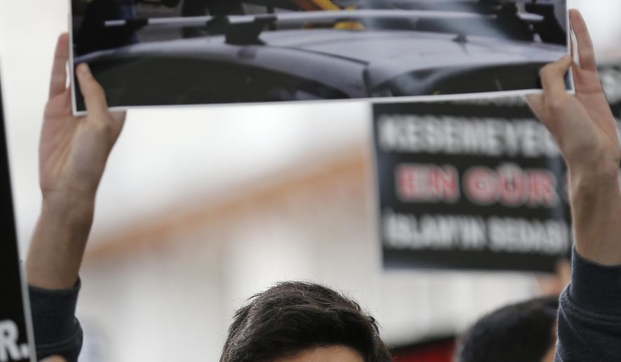 A demonstrator holding a photo from one of the scenes of the mosque attacks in New Zealand, participates in a protest in Istanbul, Friday, March 15, 2019.  World leaders expressed condolences and condemnation Friday following the deadly attacks on mosques in the New Zealand city of Christchurch, while Muslim leaders said the mass shooting was evidence of a rising tide of violent anti-Islam sentiment. (AP Photo/Lefteris Pitarakis)