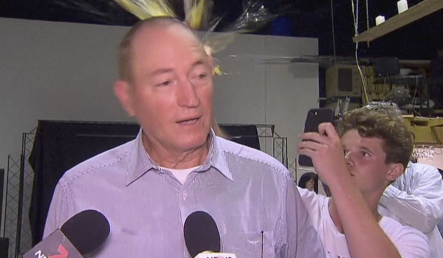 In this image made from video, a teenager breaks an egg on the head of Senator Fraser Anning while he holds a press conference, Saturday, March 16, 2019, in Melbourne, New Zealand. Following the mass shootings on Friday, Anning came under sharp criticism over tweets including one that said: Does anyone still dispute the link between Muslim immigration and violence? (AP Photo)