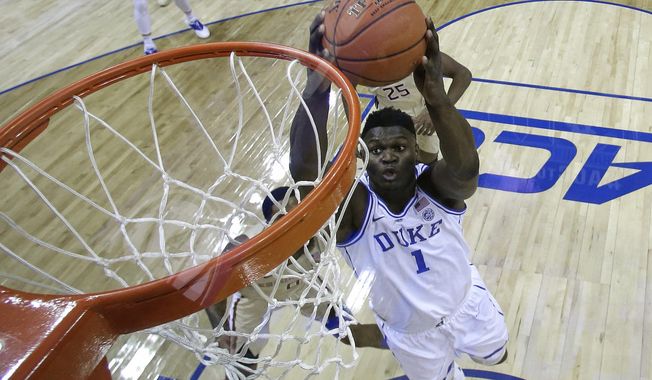 Duke&#x27;s Zion Williamson (1) goes up to dunk against Florida State during the first half of the NCAA college basketball championship game of the Atlantic Coast Conference tournament in Charlotte, N.C., Saturday, March 16, 2019. (AP Photo/Chuck Burton)
