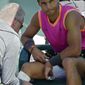 Rafael Nadal, of Spain, gets his knee wrapped by a trainer during his match against Karen Khachanov, of Russia, at the BNP Paribas Open tennis tournament Friday, March 15, 2019, in Indian Wells, Calif. (AP Photo/Mark J. Terrill)