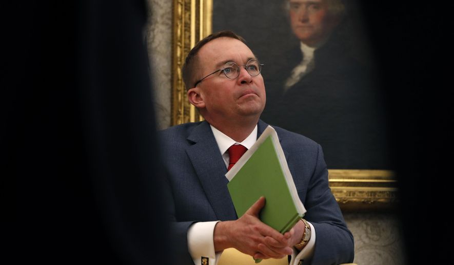 In this Jan. 31, 2019, file photo, acting White House Chief of Staff Mick Mulvaney listens as President Donald Trump speaks during a meeting with American manufacturers in the Oval Office of the White House in Washington. (AP Photo/Jacquelyn Martin) ** FILE **