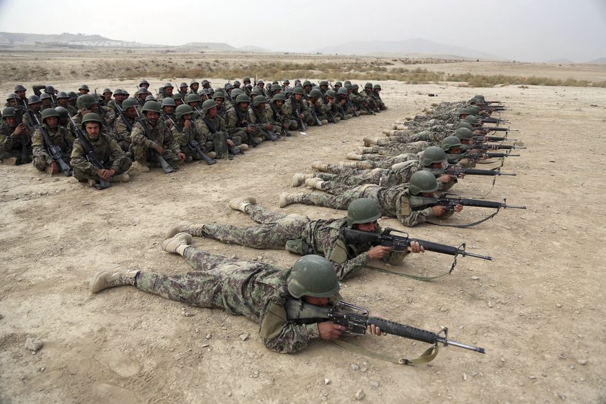FILE - In this Oct. 31, 2018, photo, Afghan National Army soldiers carry out an exercise during a live firing at the Afghan Military Academy in Kabul, Afghanistan. Afghan officials say around 100 soldiers fled their posts and tried to cross into neighboring Turkmenistan during a weeklong battle with the Taliban, in the latest setback for the country's battered security forces. Mohammad Naser Nazari, a provincial council member in the western Badghis province, said Sunday, March 17, 2019, that the soldiers were not allowed to cross the border and their fate remains unknown. (AP Photo/Rahmat Gul, File)